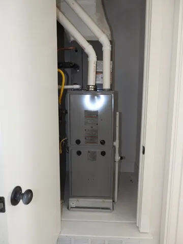 a view of a hallway with a room and wooden floor