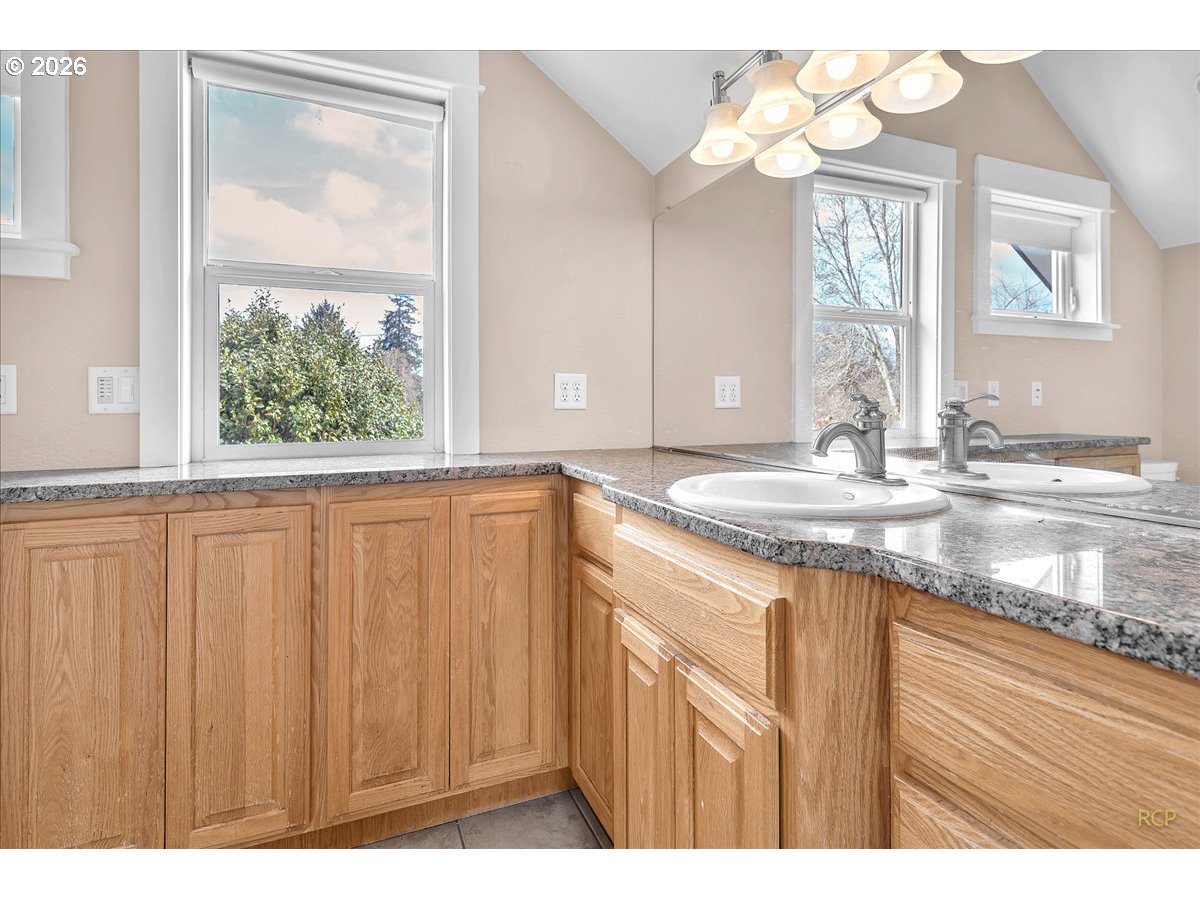 34418 Berg Road Warren, OR 97053 - Photo 19 of 39 a bathroom with a granite countertop sink and a large mirror