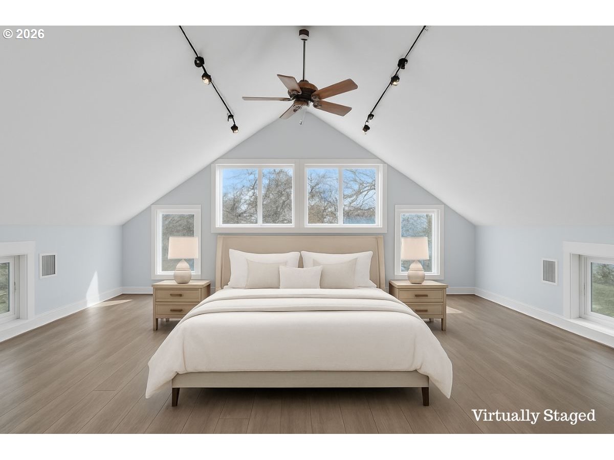 34418 Berg Road Warren, OR 97053 - Photo 21 of 39 a bedroom with a large bed and a chandelier