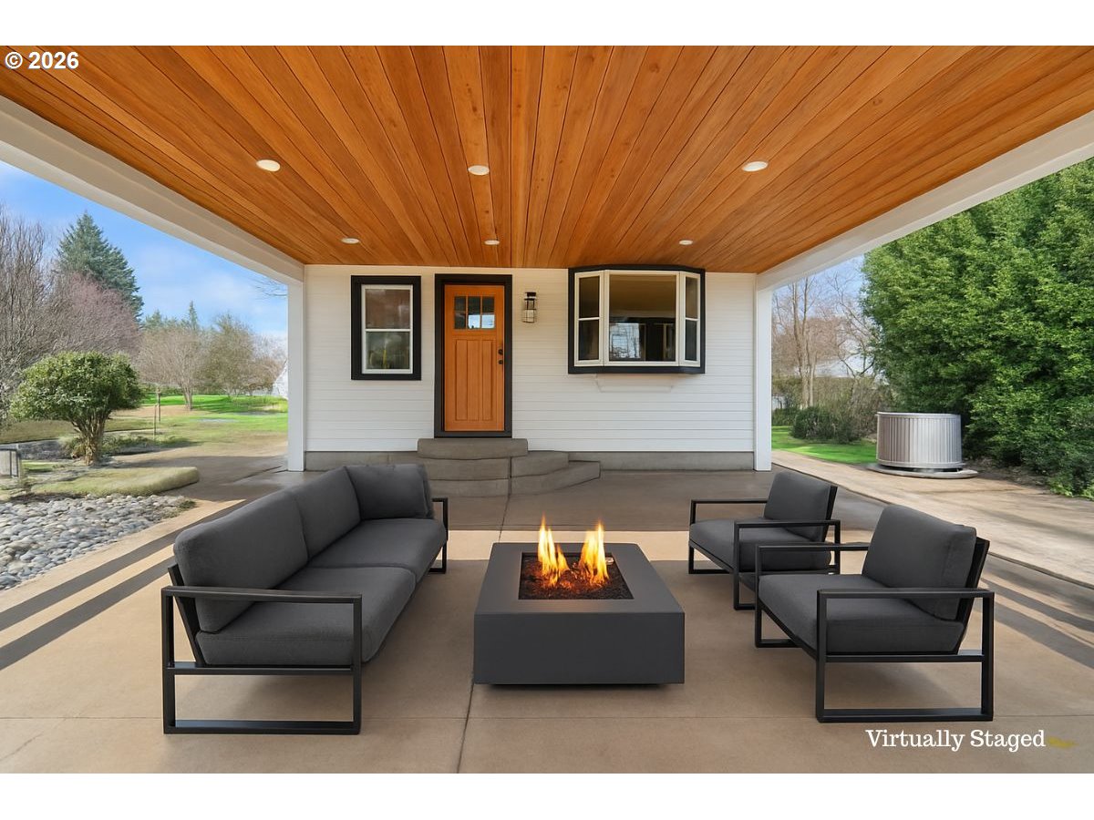 34418 Berg Road Warren, OR 97053 - Photo 23 of 39 a outdoor living space with furniture and a floor to ceiling window