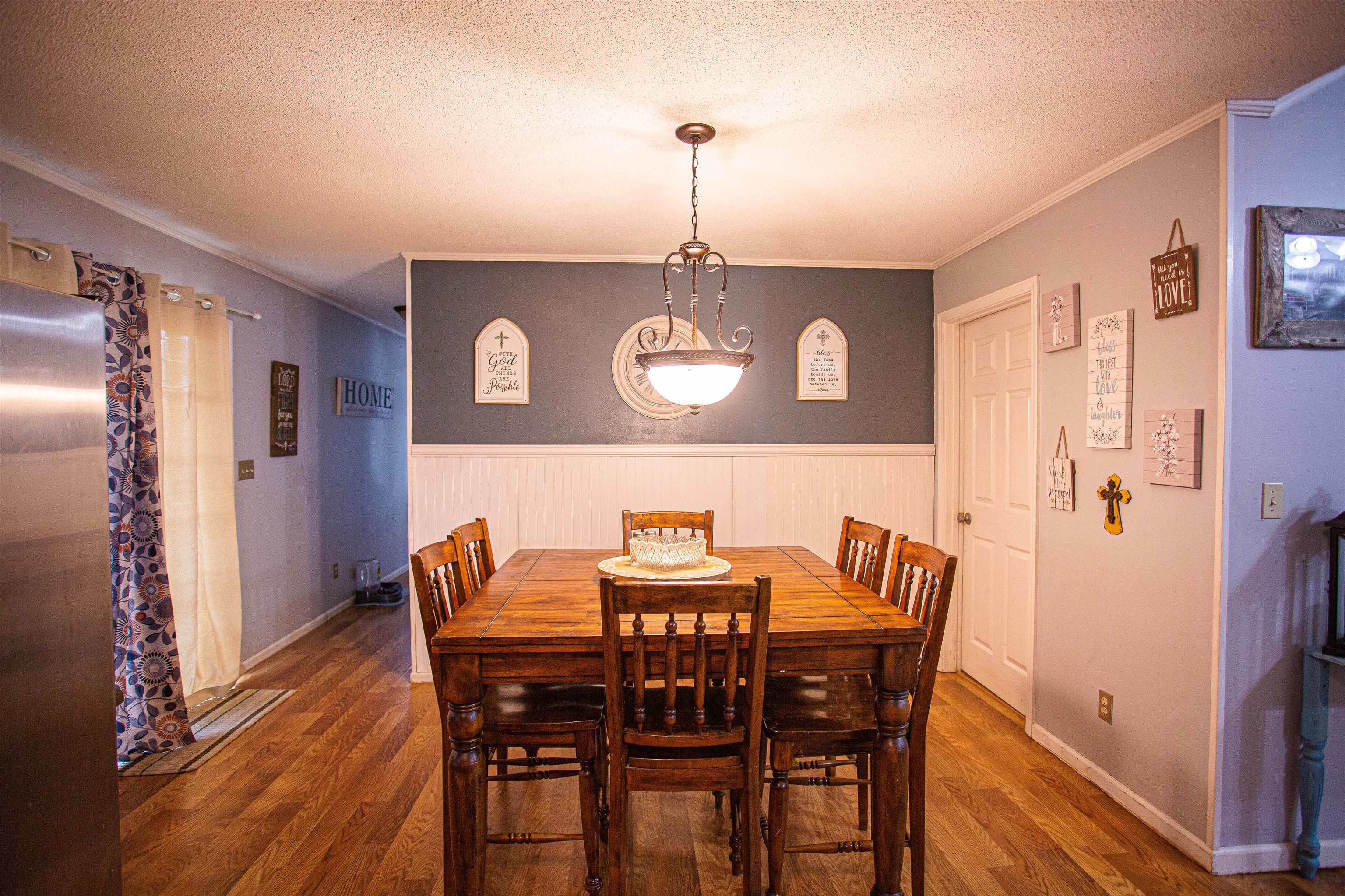 370 Dr Lewis Road Ripley, TN 38063 - Photo 7 of 25 a view of a dining room with furniture and wooden floor