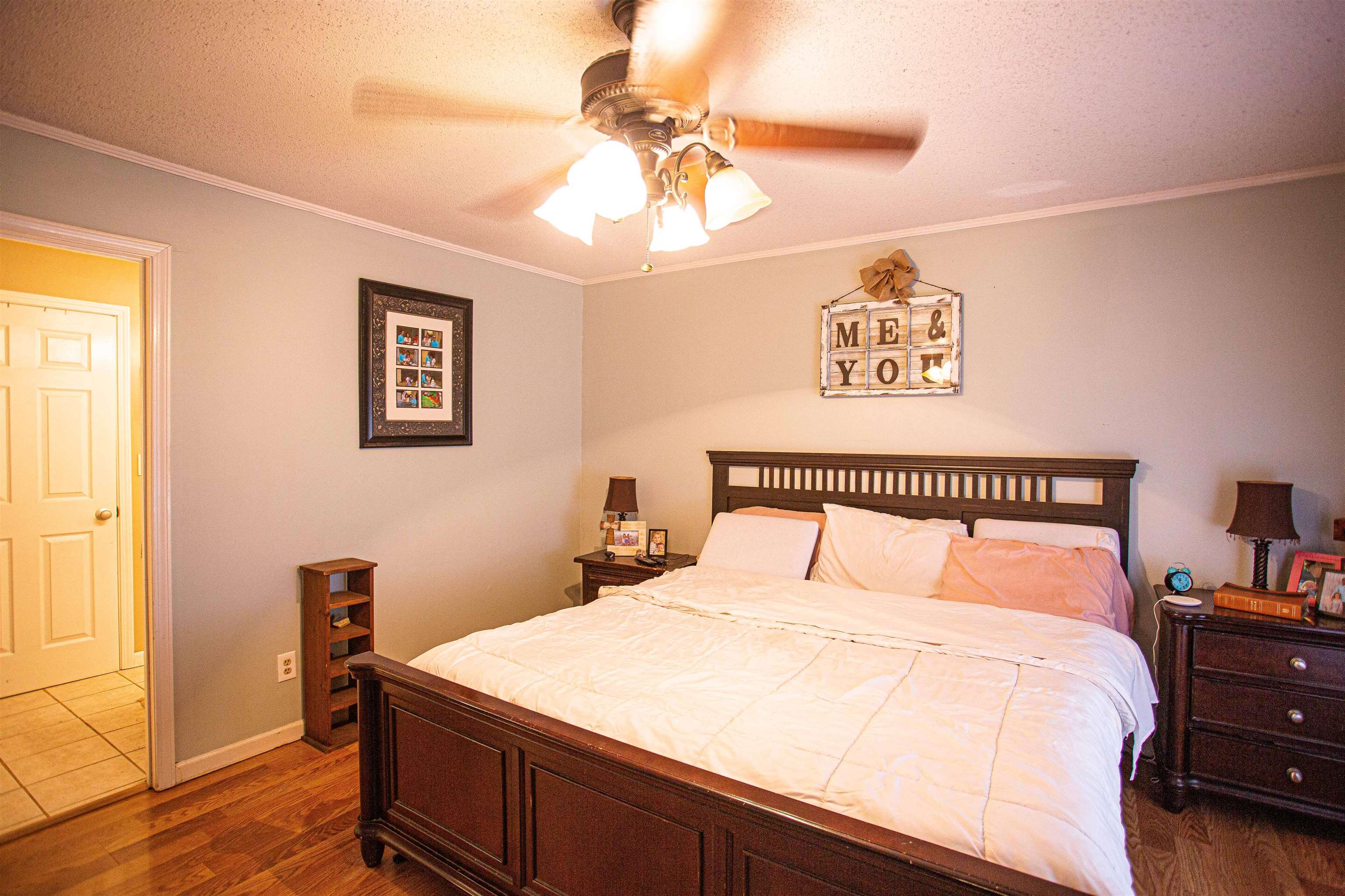 370 Dr Lewis Road Ripley, TN 38063 - Photo 10 of 25 a bedroom with a bed and a chandelier