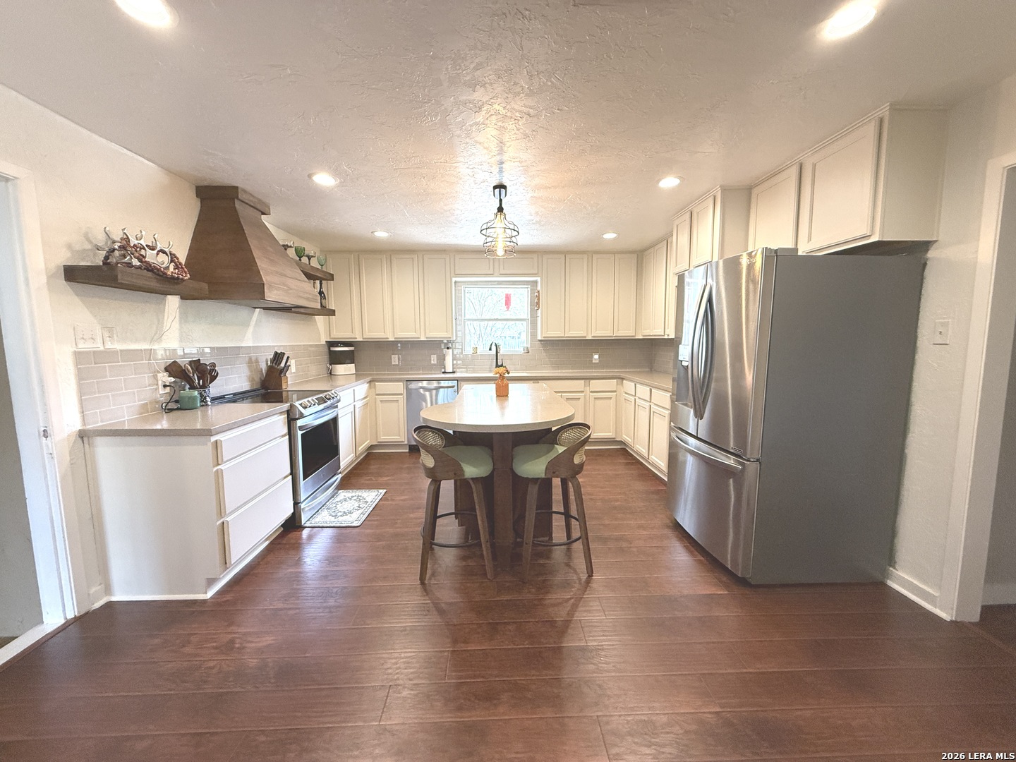 908 29th Street Hondo, TX 78861 - Photo 14 of 37 a kitchen with stainless steel appliances a dining table chairs refrigerator and sink