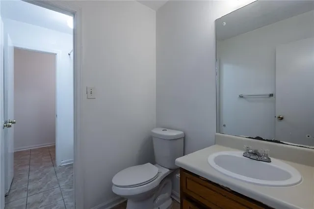 a bathroom with a sink toilet and a mirror