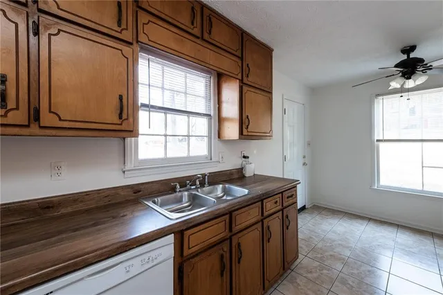 a kitchen with stainless steel appliances granite countertop a sink a stove and a microwave