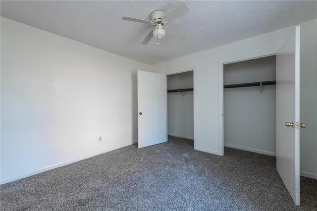 a view of an empty room with a ceiling fan