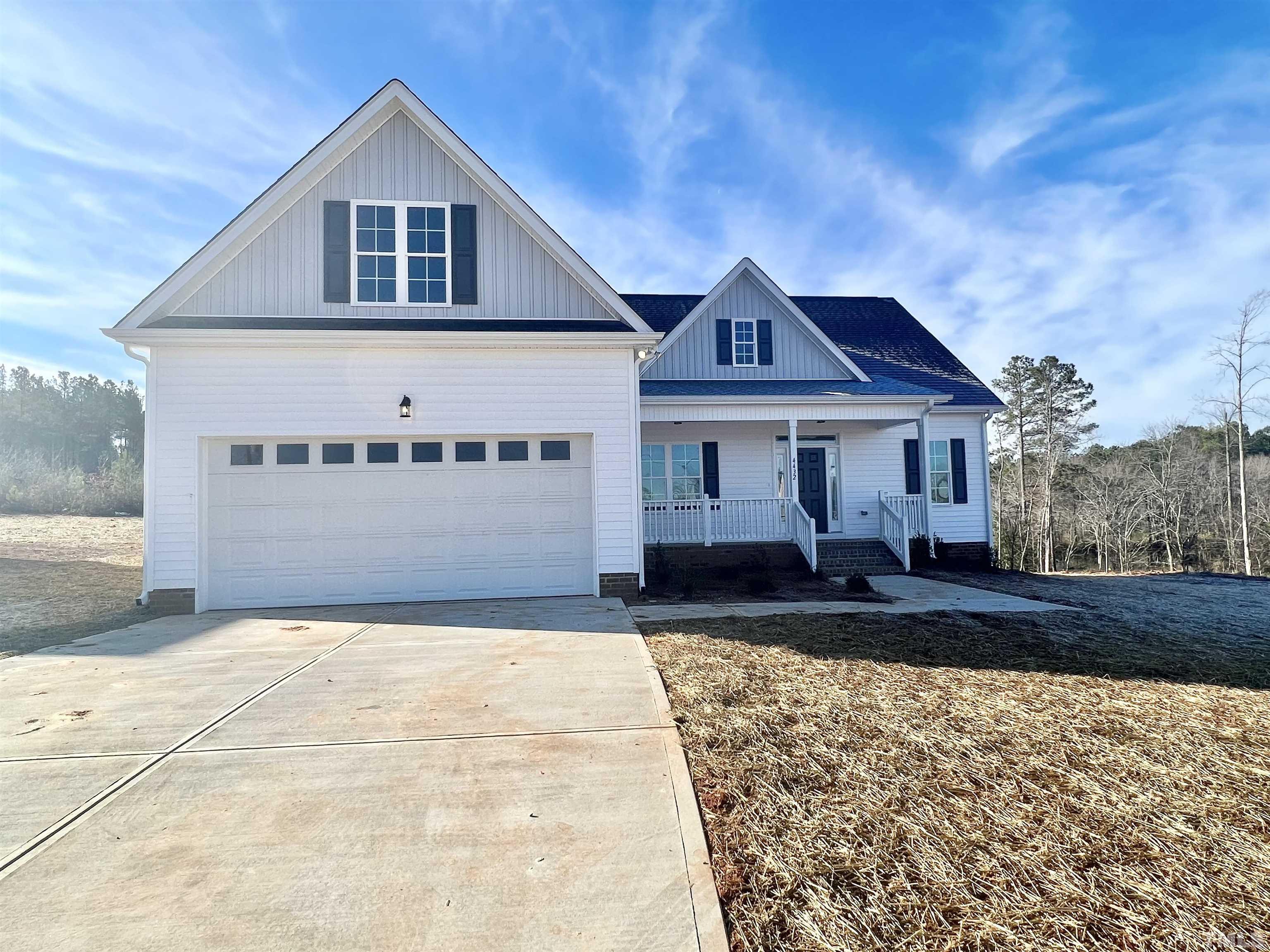 4432 Debnam Road Zebulon, NC 27597 - Photo 2 of 9 a front view of a house with a yard