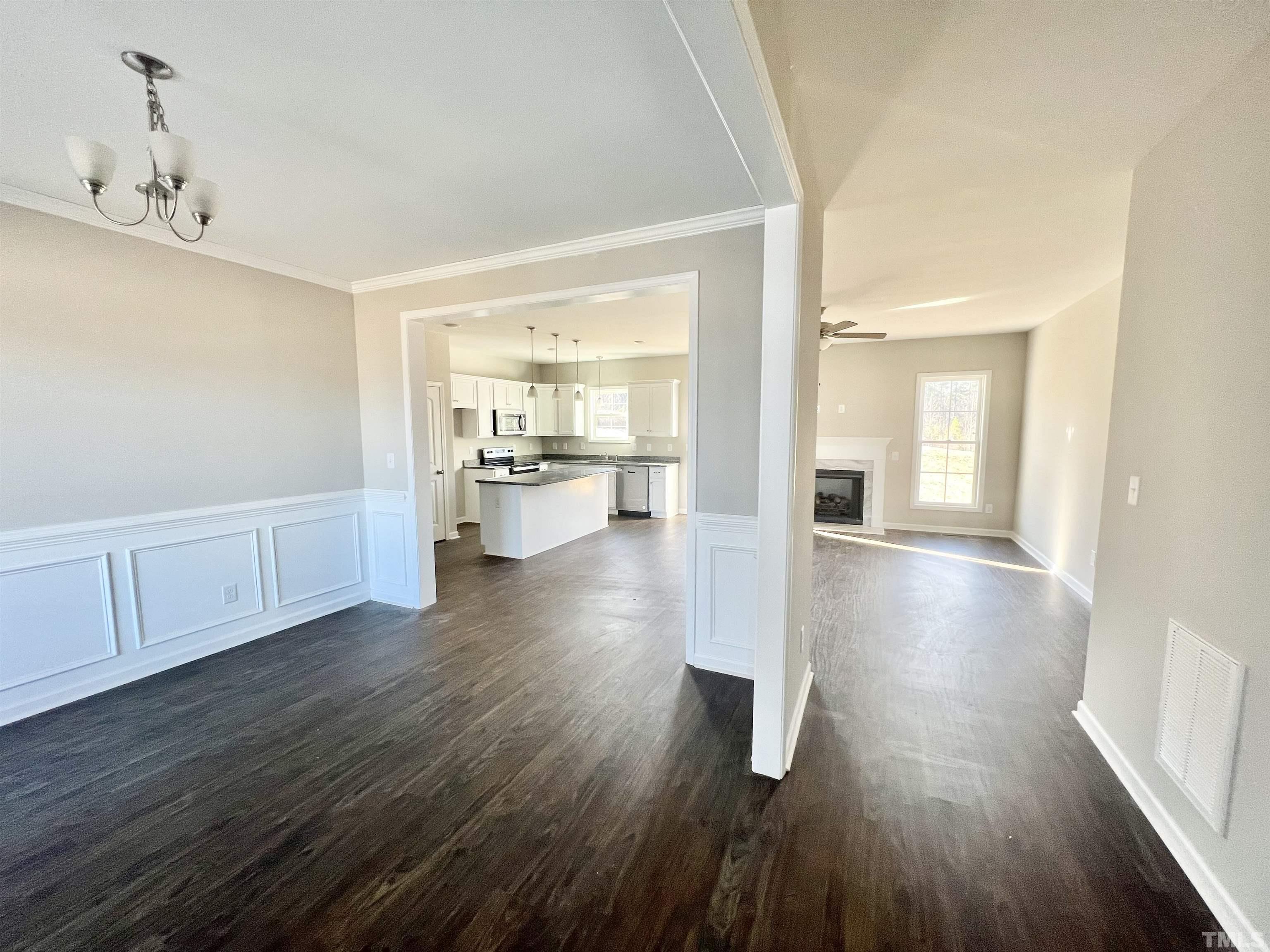 4432 Debnam Road Zebulon, NC 27597 - Photo 3 of 9 a view of a kitchen with wooden floor and a sink
