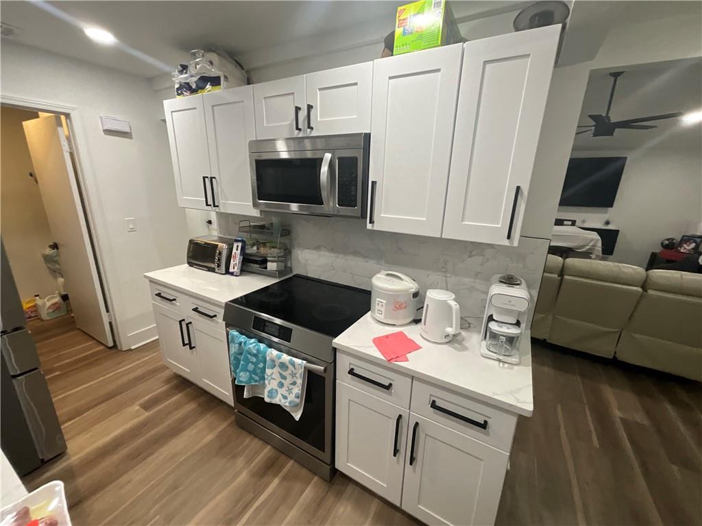 3155 Tangerine Court, Unit 3155 Decatur, GA 30034 - Photo 20 of 24 a kitchen with stainless steel appliances a stove a sink a refrigerator and wooden floor