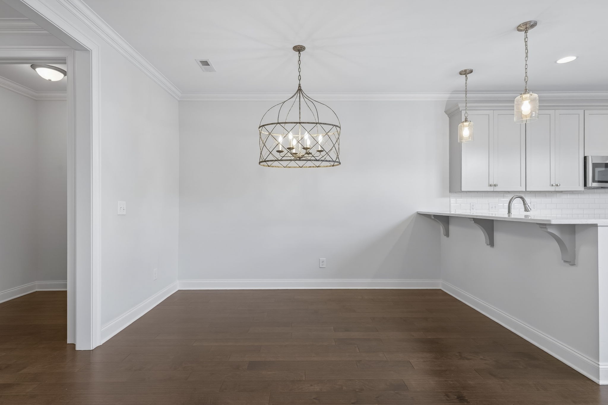 3062 Cheever Street Franklin, TN 37064 - Photo 11 of 51 a view of a room with cabinet wooden floor and a chandelier