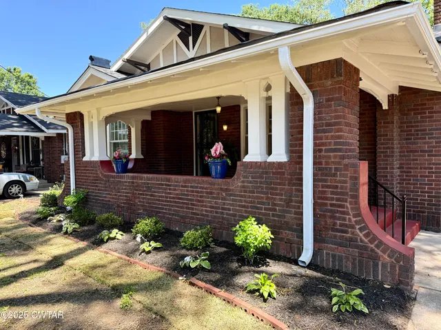 a view of a house with potted plants