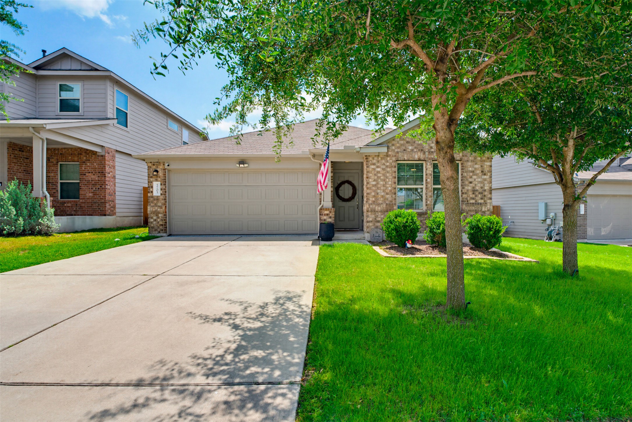 A well-maintained lawn and sturdy driveway welcome you to this charming brick residence.