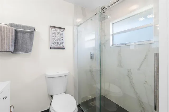 a white toilet sitting next to a bathroom sink