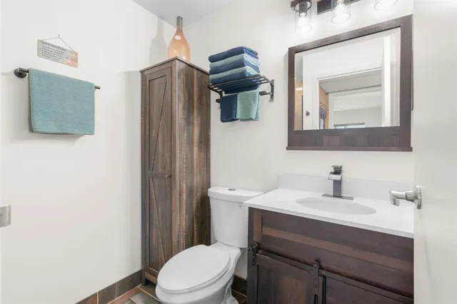 a bathroom with a toilet sink and mirror