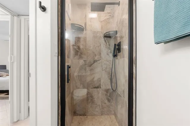 a bathroom with a glass shower door