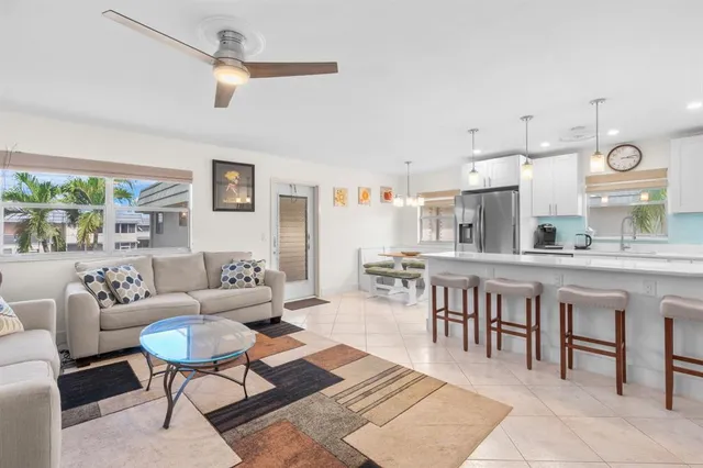 a living room with furniture a rug and white walls