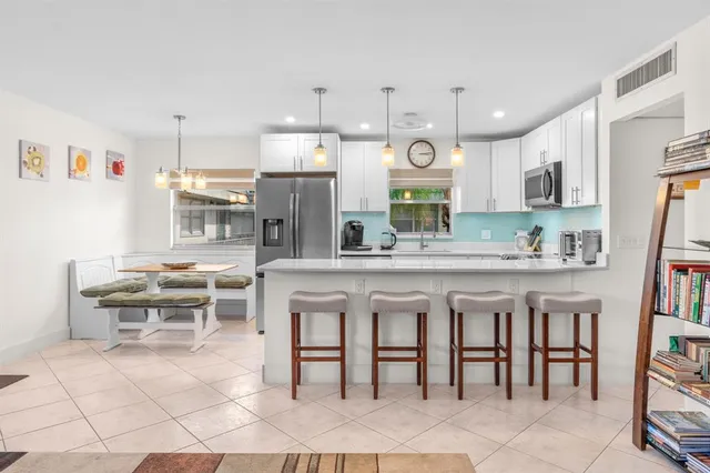 a kitchen with stainless steel appliances kitchen island granite countertop a sink and cabinets