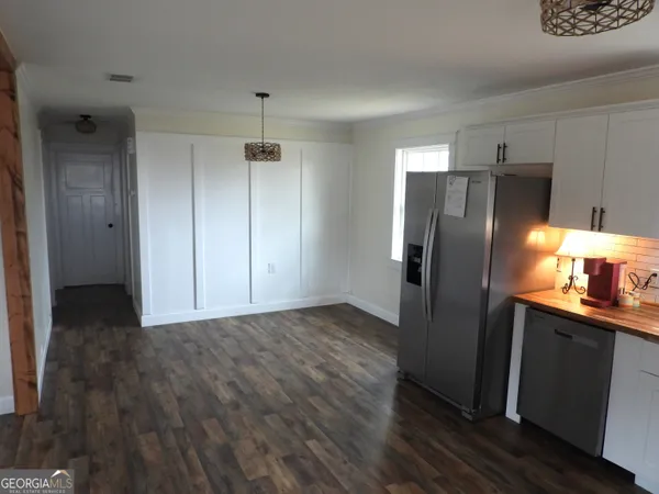 a kitchen with granite countertop a refrigerator and a sink