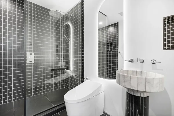 a bathroom with a sink a toilet and shower