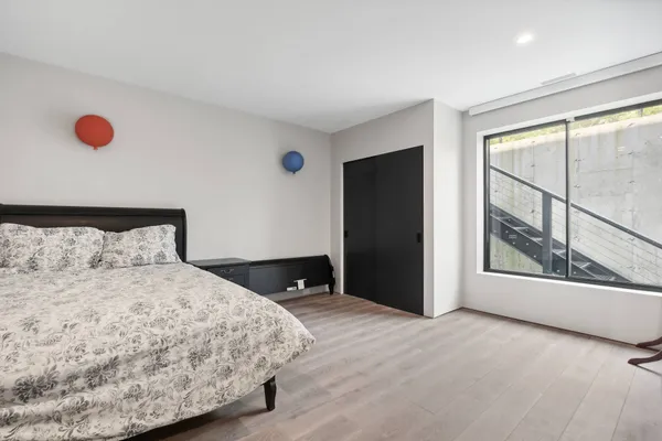 a bedroom with a bed and window