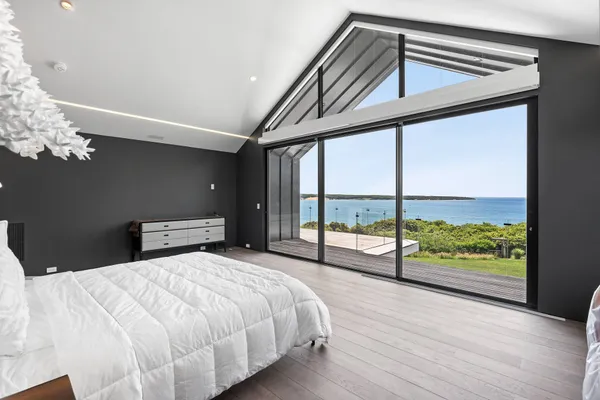 a bedroom with a large bed and a large window