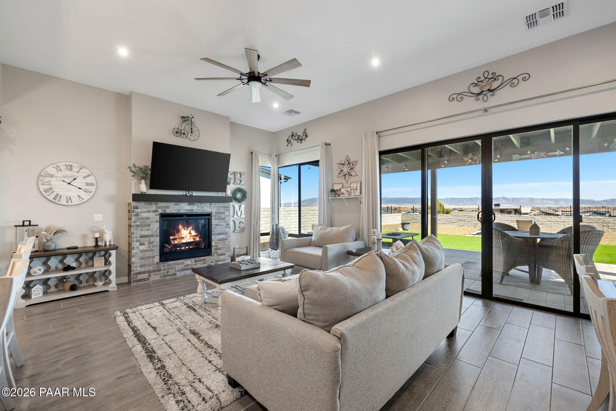 4882 North Yorkshire Loop Prescott Valley, AZ 86314 - Photo 14 of 28 a living room with furniture a fireplace and a flat screen tv