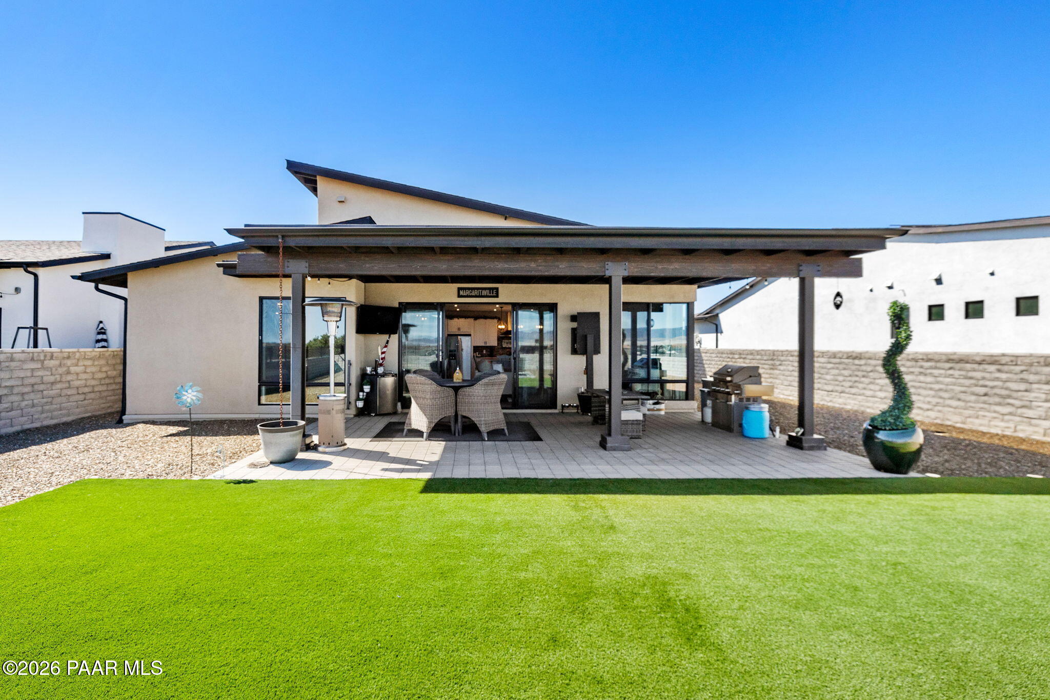 4882 North Yorkshire Loop Prescott Valley, AZ 86314 - Photo 23 of 28 a view of a patio with a table and chairs under an umbrella
