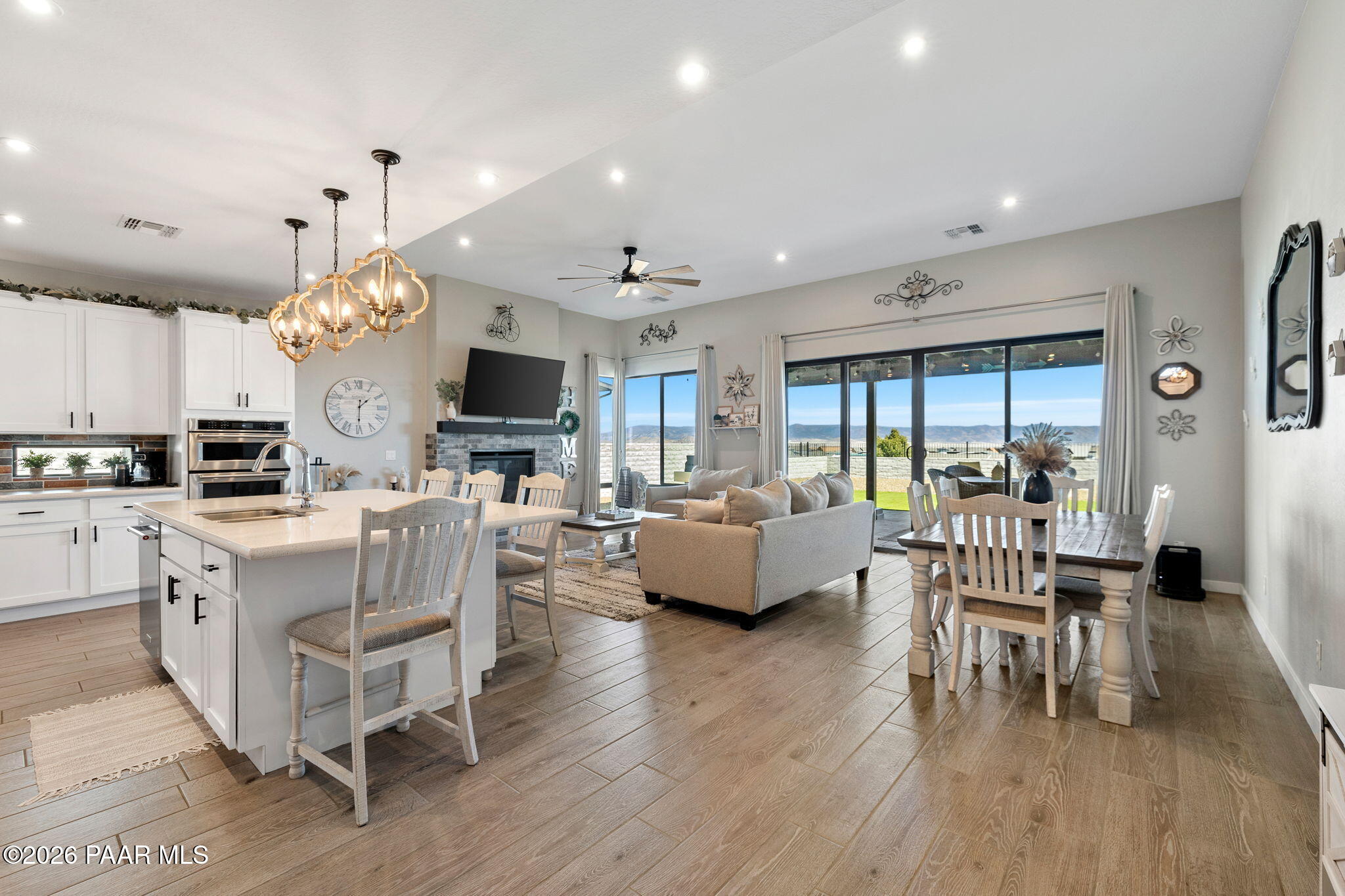4882 North Yorkshire Loop Prescott Valley, AZ 86314 - Photo 7 of 28 a living room with furniture a fireplace and a dining table with wooden floor