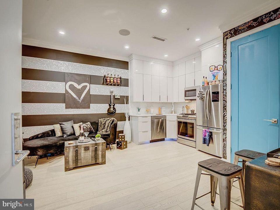 3527 14th Street Northwest, Unit 2 Washington, DC 20010 - Photo 5 of 9 a kitchen with stainless steel appliances granite countertop a sink and cabinets