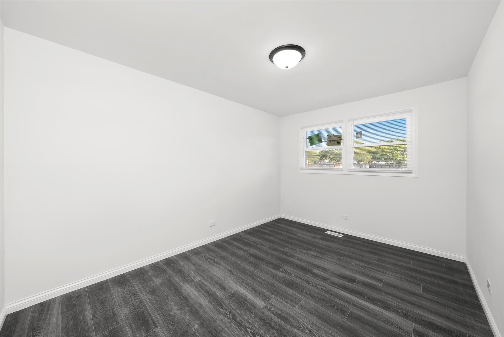 3619 West 163rd Street Markham, IL 60428 - Photo 12 of 40 an empty room with wooden floor and windows