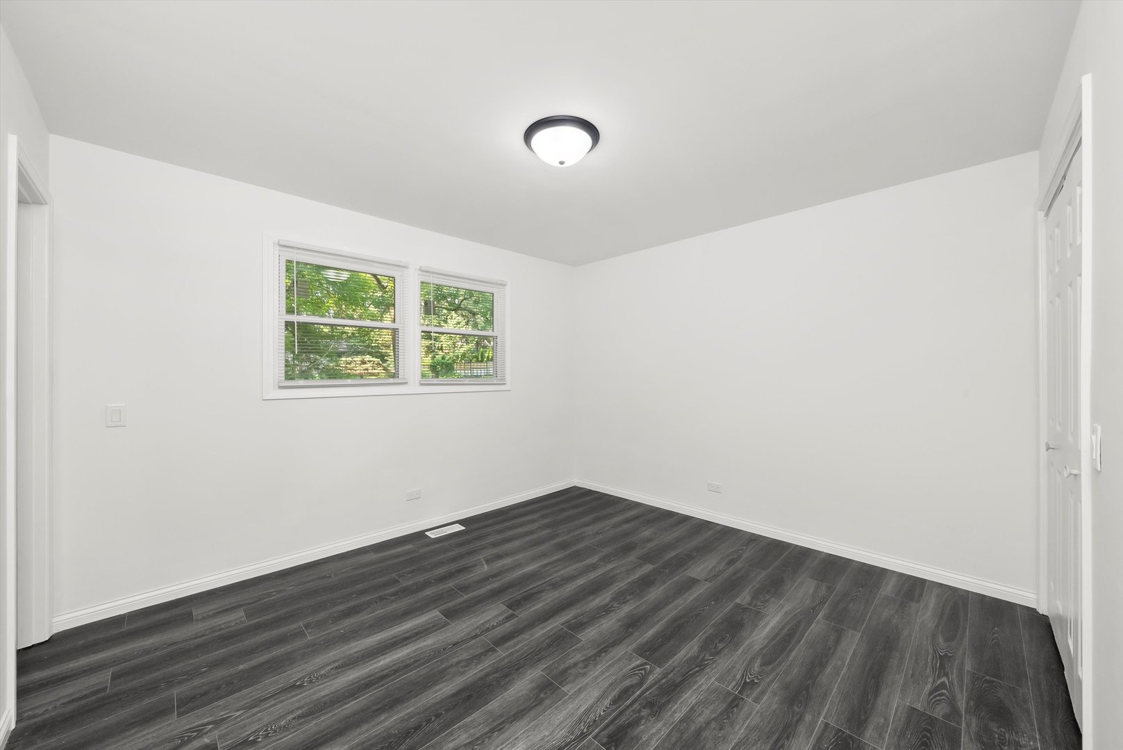 3619 West 163rd Street Markham, IL 60428 - Photo 16 of 40 an empty room with wooden floor and windows