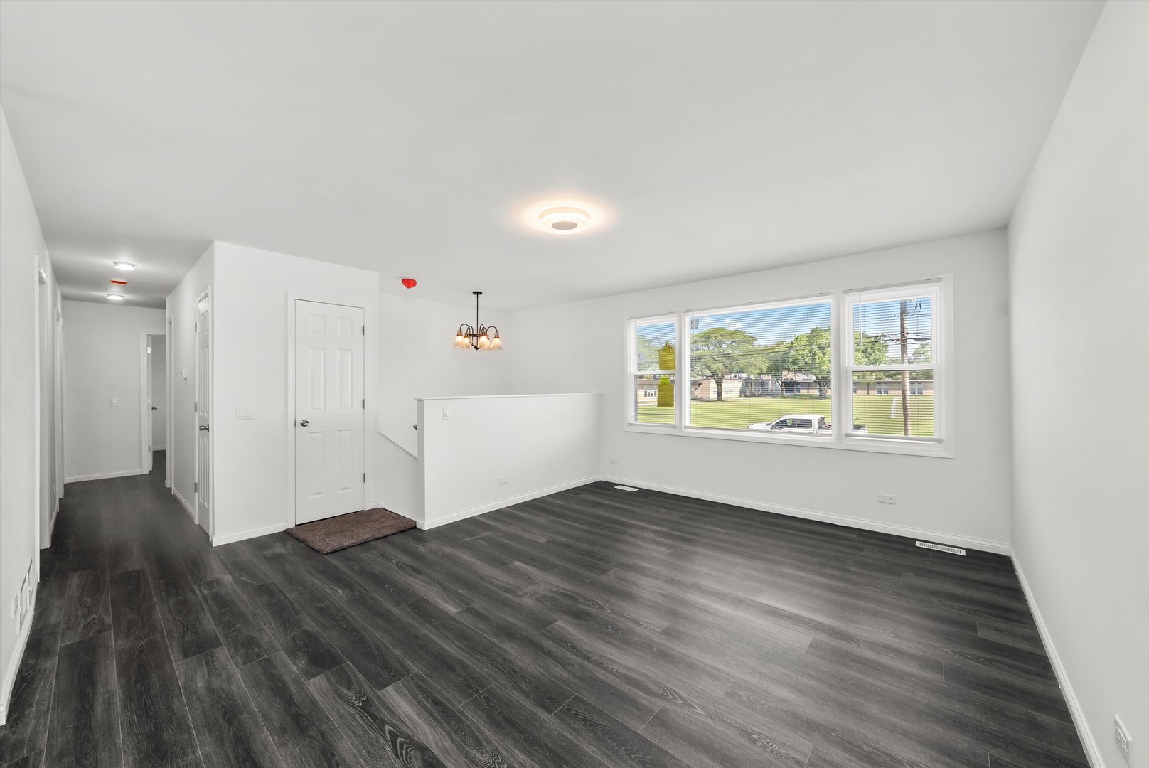 3619 West 163rd Street Markham, IL 60428 - Photo 19 of 40 an empty room with wooden floor and windows
