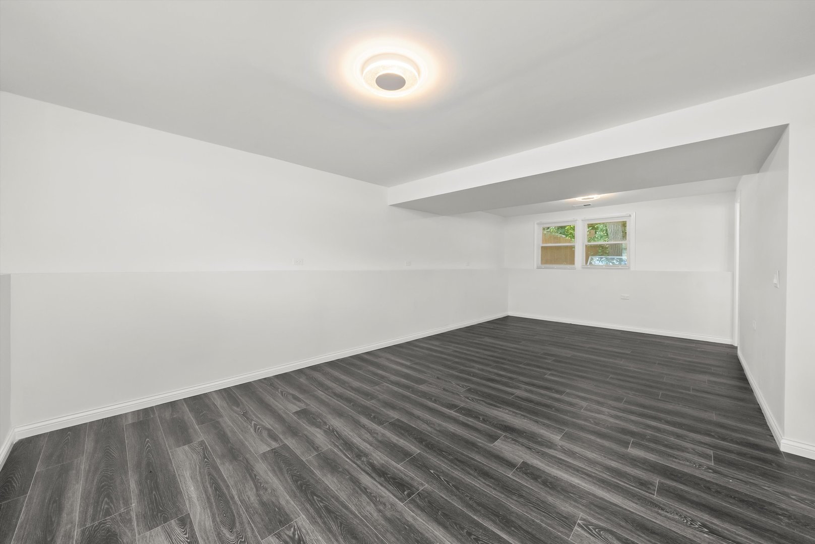 3619 West 163rd Street Markham, IL 60428 - Photo 23 of 40 a view of an empty room with wooden floor and a window