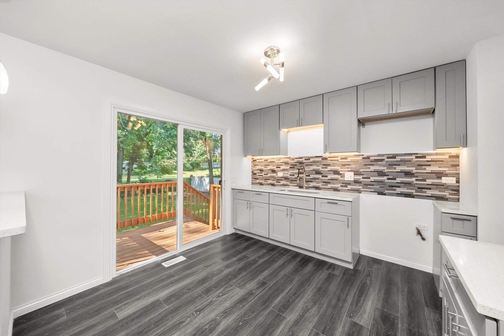 3619 West 163rd Street Markham, IL 60428 - Photo 9 of 40 a kitchen with granite countertop white cabinets and wooden floor