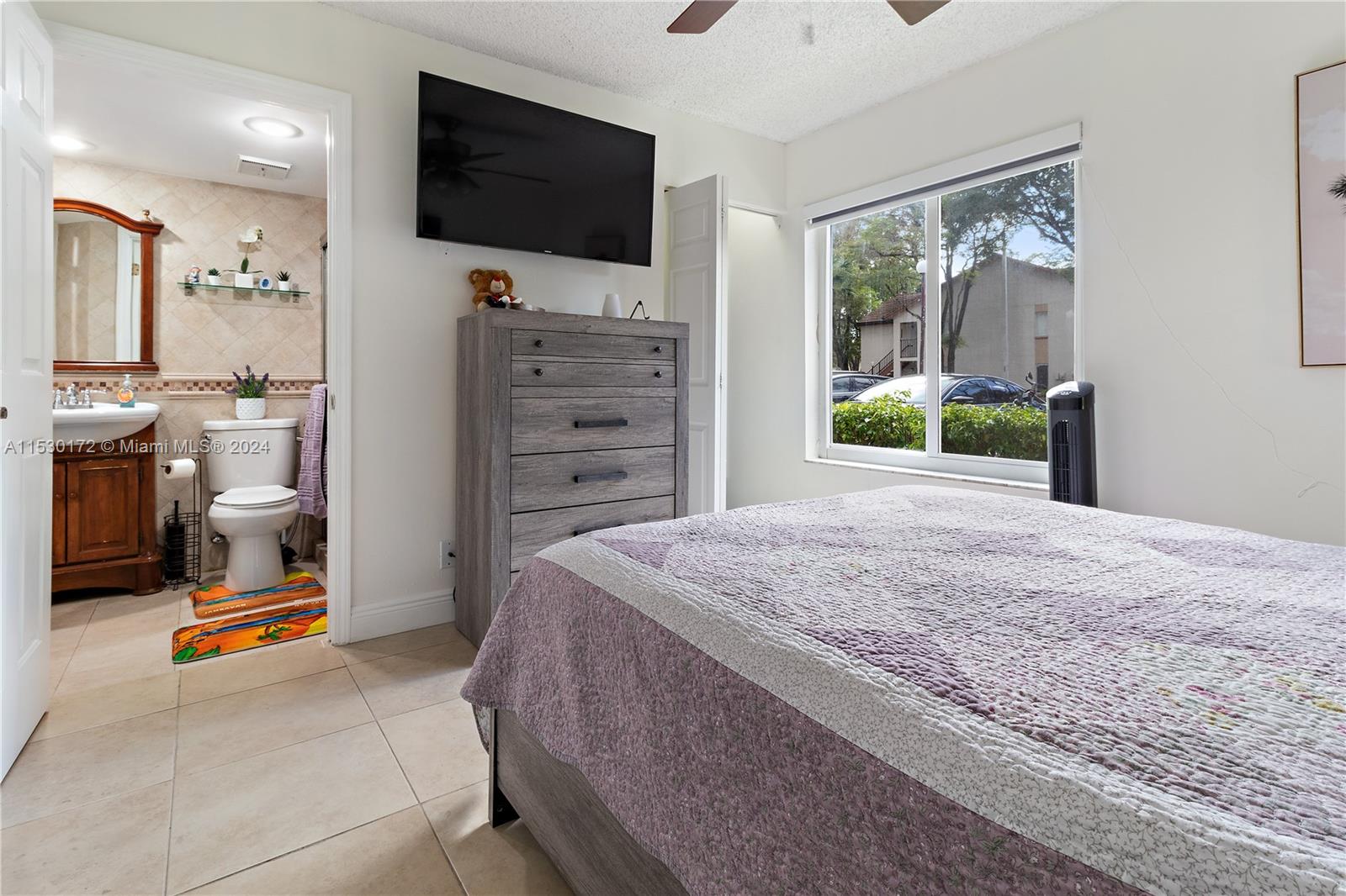 9201 Southwest 138th Place, Unit 9201 Miami, FL 33186 - Photo 11 of 20 a bedroom with a bed and a flat screen tv