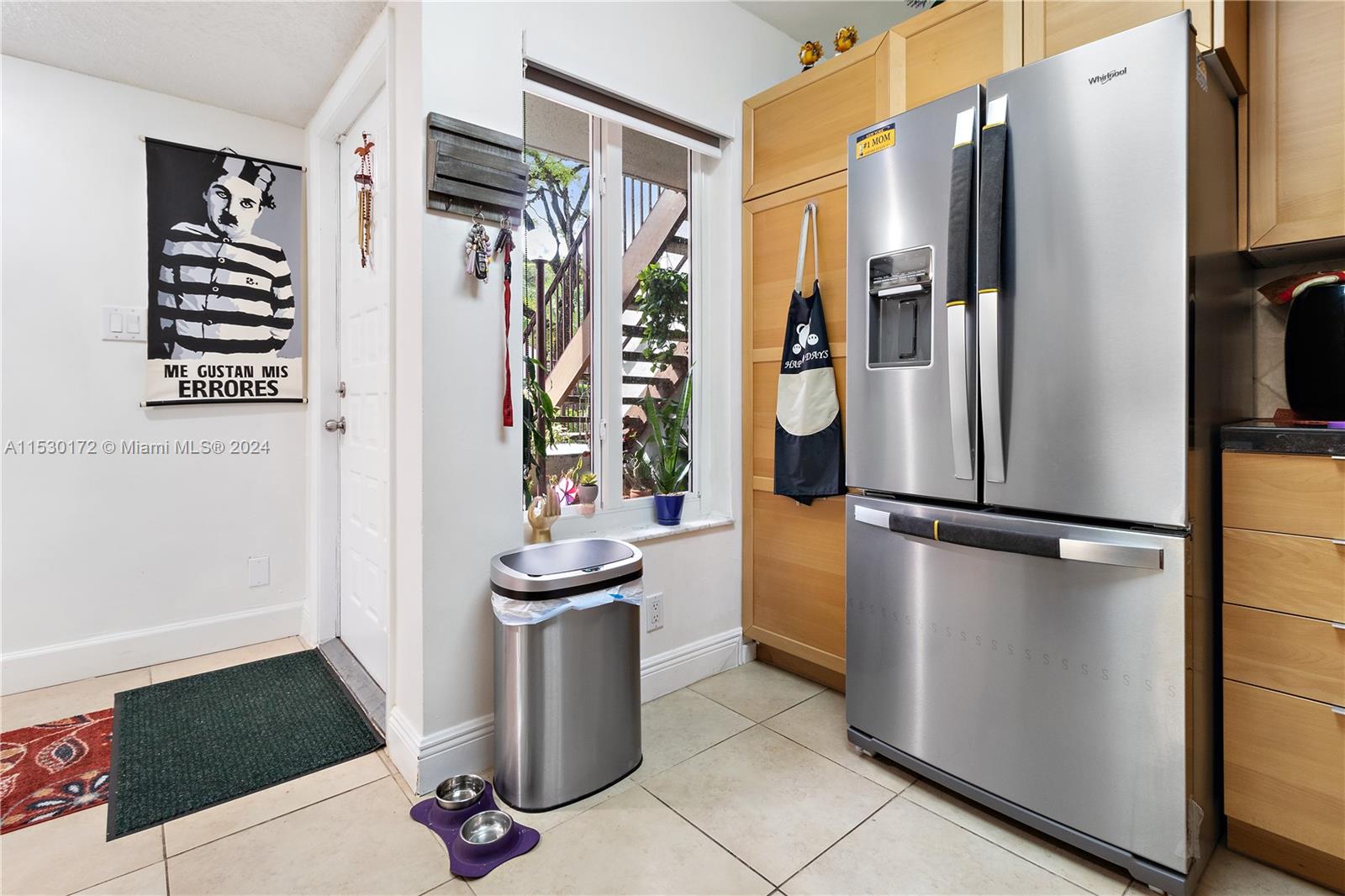9201 Southwest 138th Place, Unit 9201 Miami, FL 33186 - Photo 13 of 20 a view of a kitchen with fridge and wooden floor