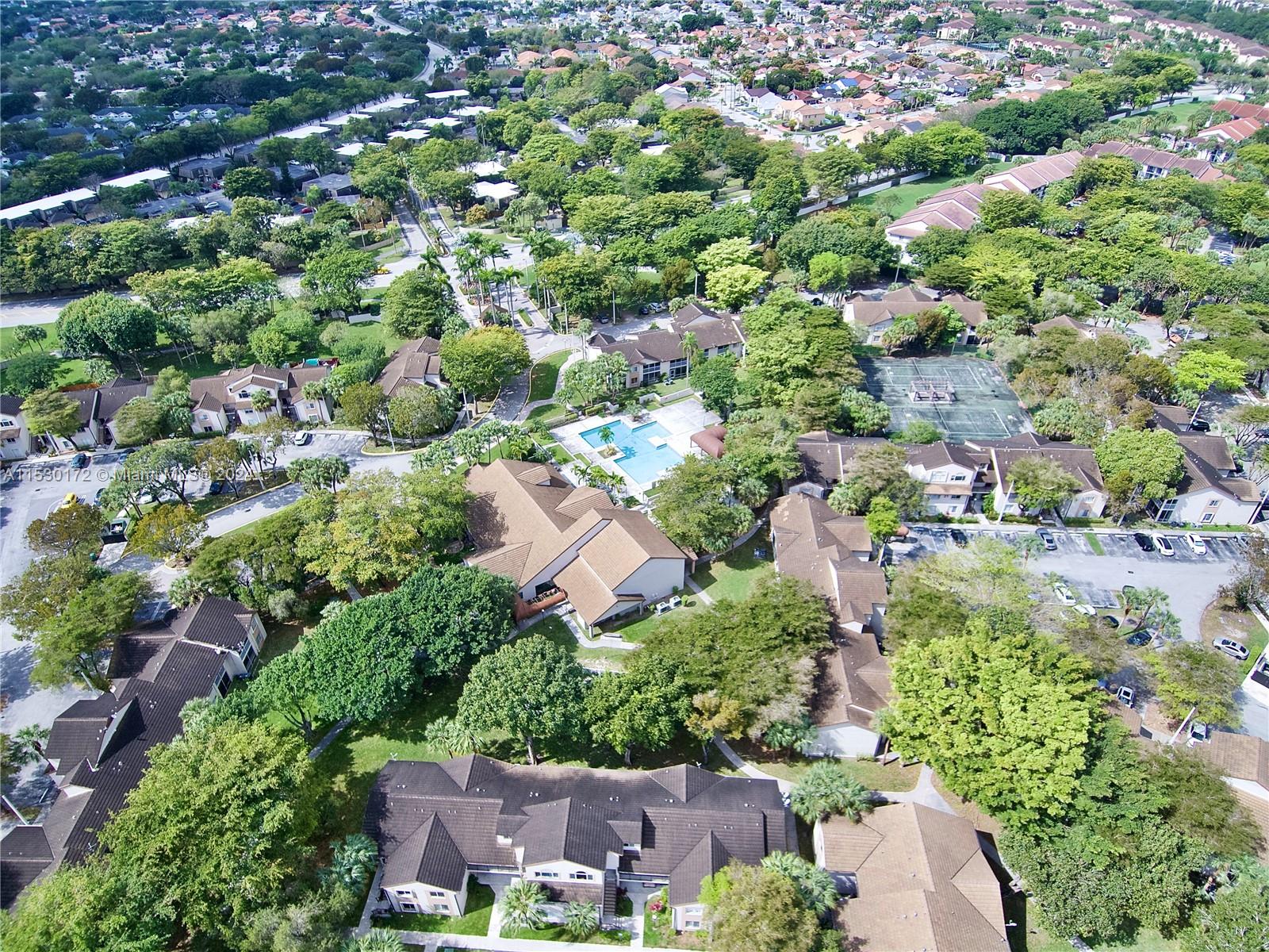 9201 Southwest 138th Place, Unit 9201 Miami, FL 33186 - Photo 19 of 20 an aerial view of residential house with outdoor space and trees all around