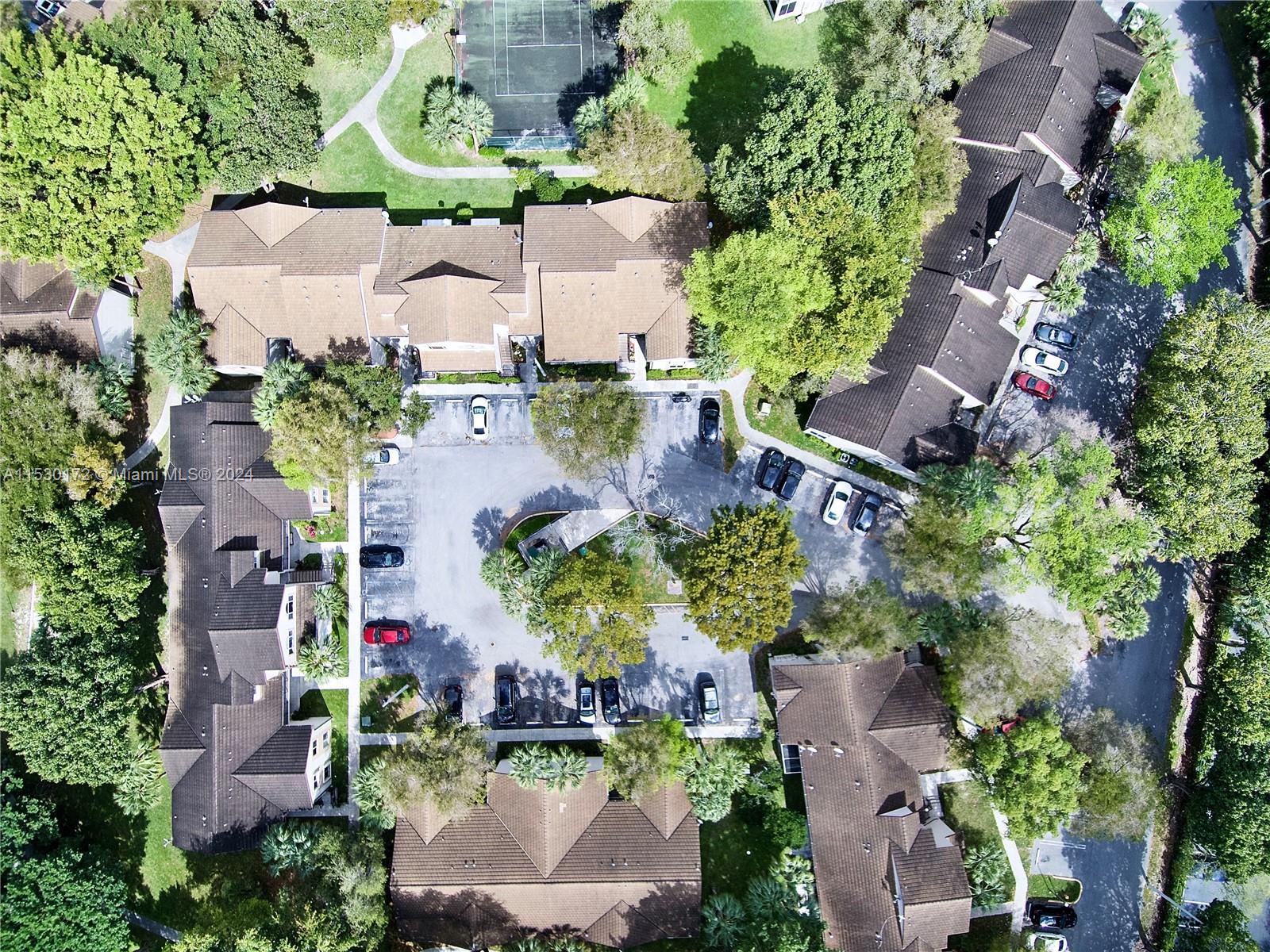 9201 Southwest 138th Place, Unit 9201 Miami, FL 33186 - Photo 20 of 20 an aerial view of a house with a yard and tennis court