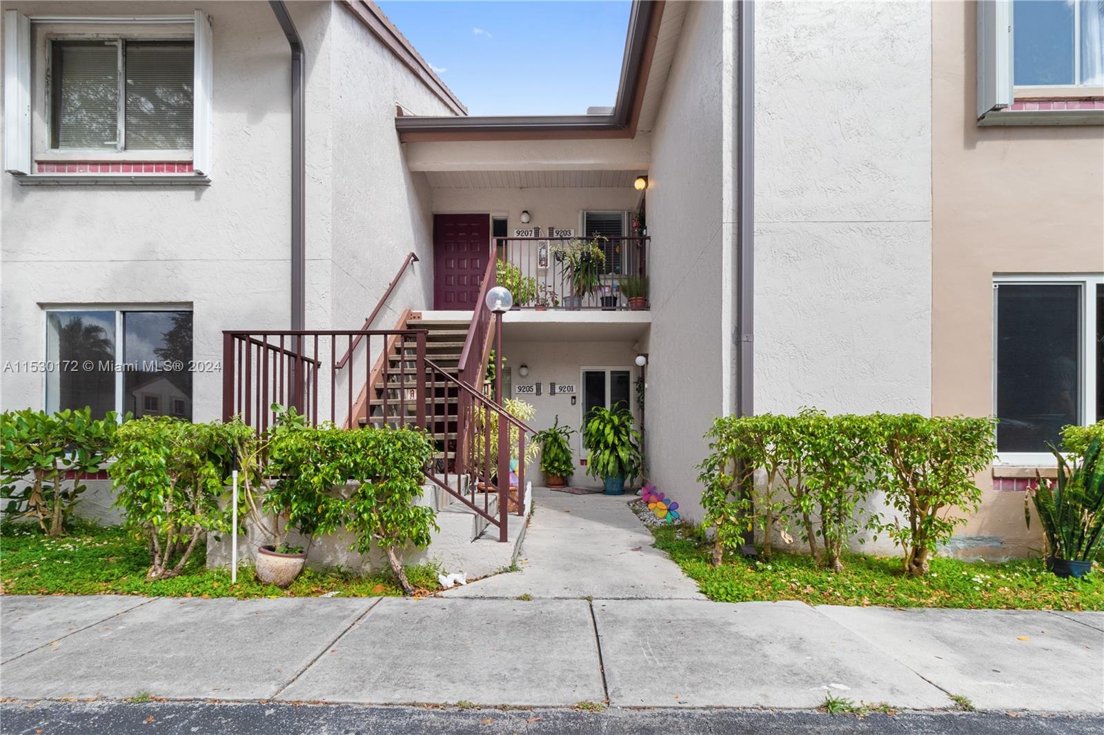9201 Southwest 138th Place, Unit 9201 Miami, FL 33186 - Photo 2 of 20 a view of a house with potted plants