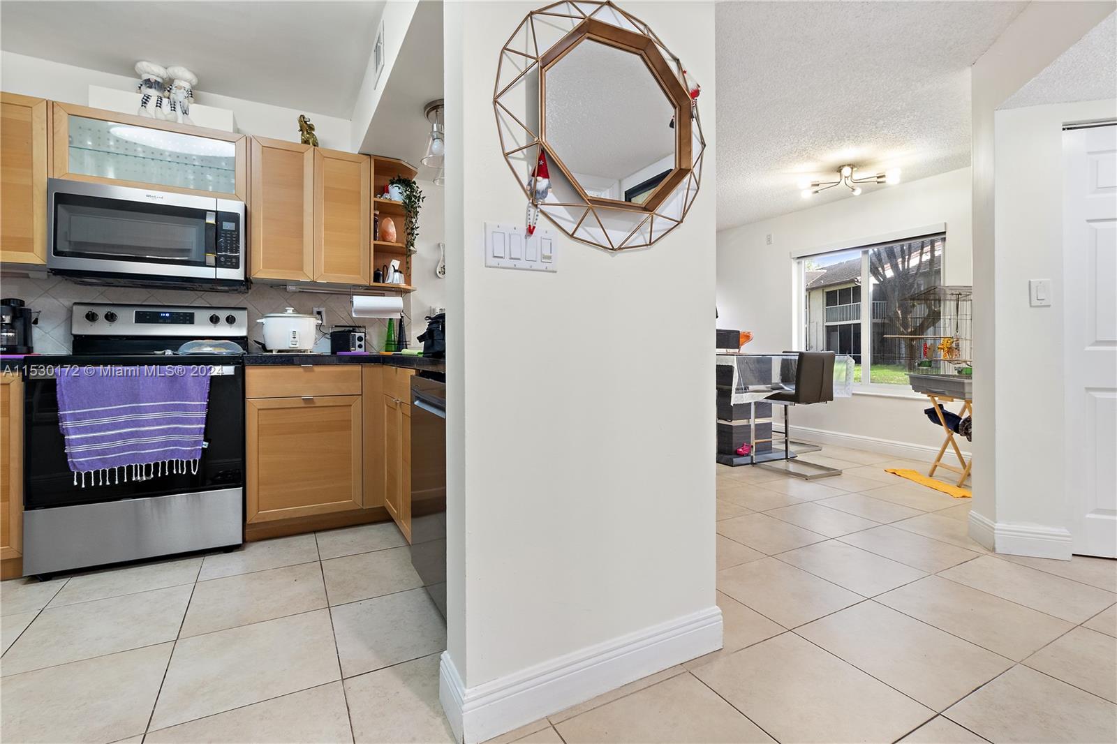 9201 Southwest 138th Place, Unit 9201 Miami, FL 33186 - Photo 4 of 20 a view of a kitchen with fridge and workspace
