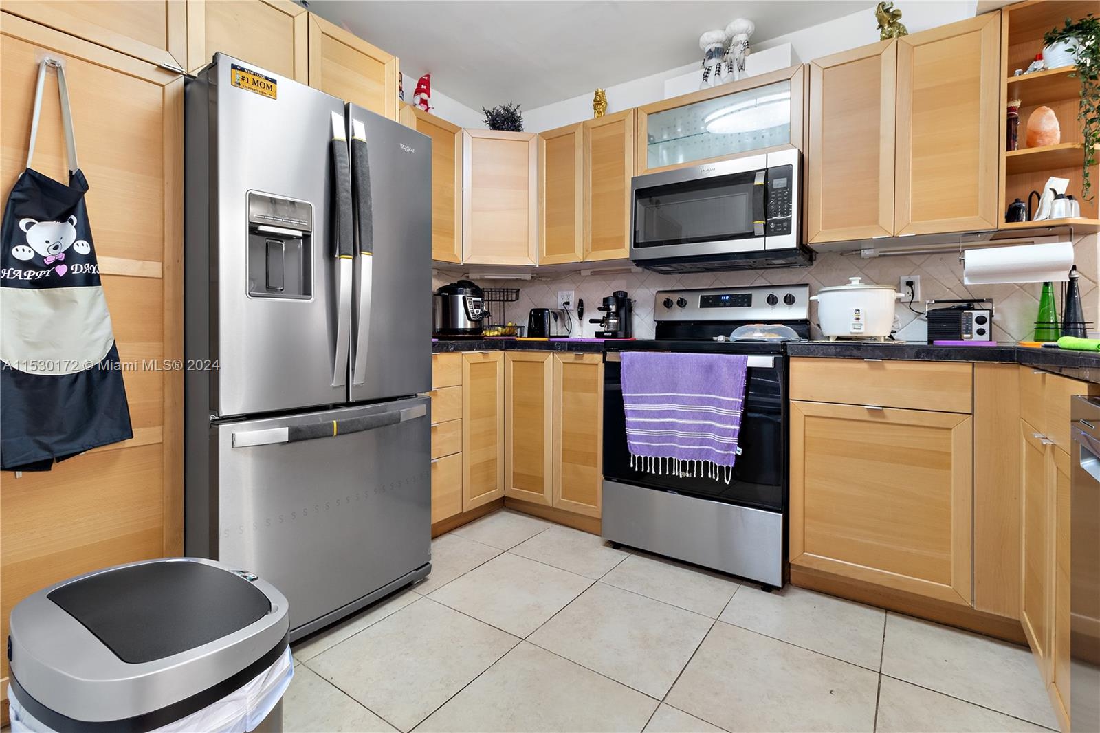9201 Southwest 138th Place, Unit 9201 Miami, FL 33186 - Photo 5 of 20 a kitchen with stainless steel appliances granite countertop a refrigerator a stove a sink and a microwave