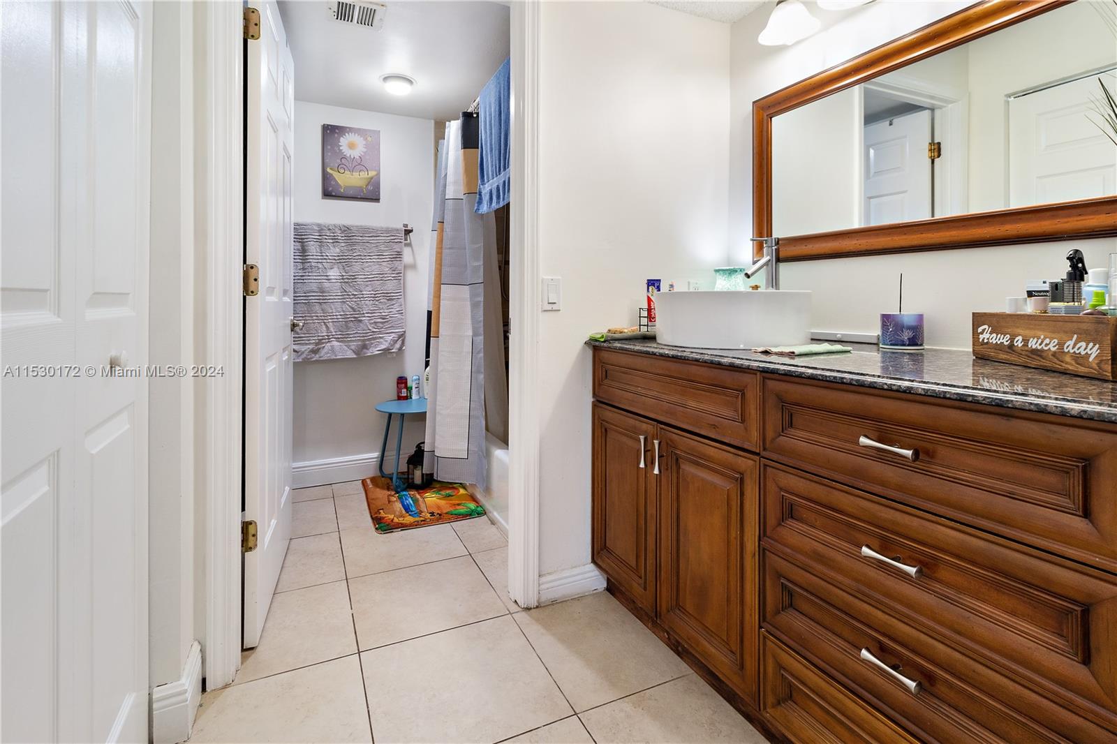 9201 Southwest 138th Place, Unit 9201 Miami, FL 33186 - Photo 6 of 20 a hallway with sink and mirror