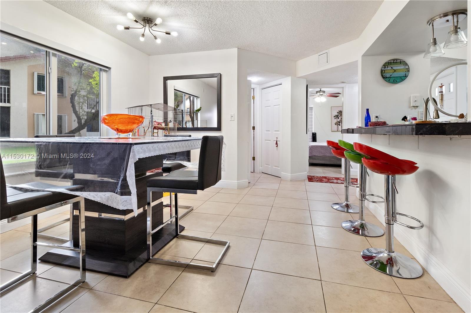 9201 Southwest 138th Place, Unit 9201 Miami, FL 33186 - Photo 8 of 20 a living room with furniture and natural light