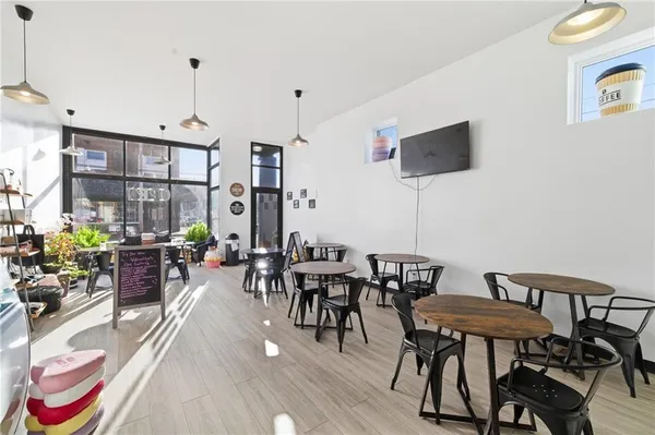 a view of a dining room with furniture window and wooden floor
