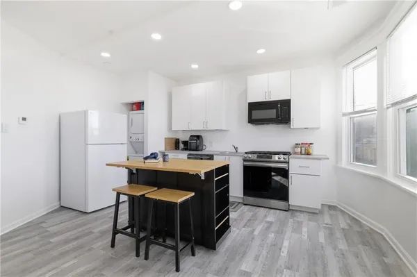 a kitchen with a stove a sink and a refrigerator