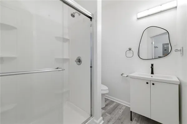 a bathroom with a toilet sink and shower