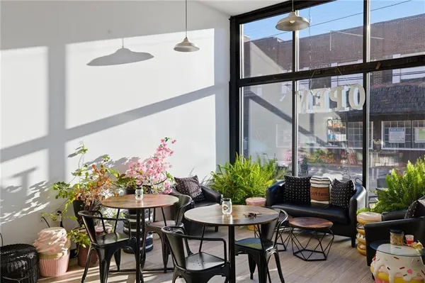 a view of a dining room with furniture and a potted plant
