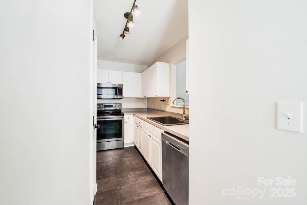 5622 Osprey Cove Drive Raleigh, NC 27604 - Photo 12 of 30 a kitchen with cabinets stainless steel appliances and a window