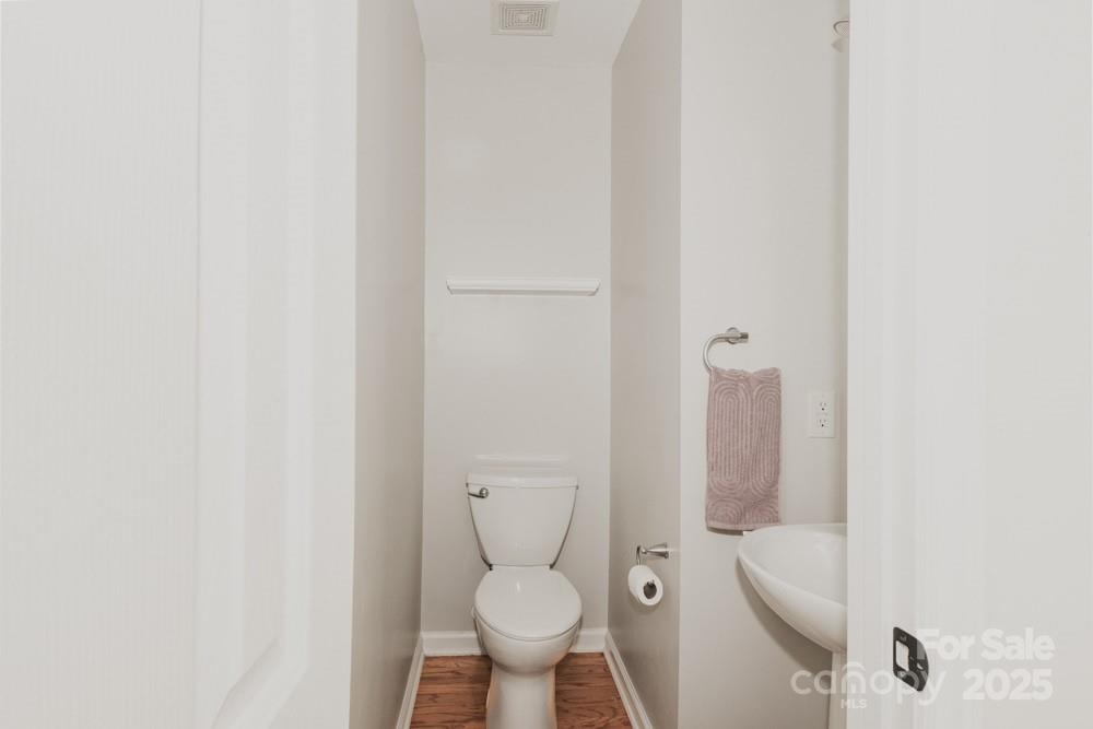 5622 Osprey Cove Drive Raleigh, NC 27604 - Photo 14 of 30 a white toilet sitting next to a white sink