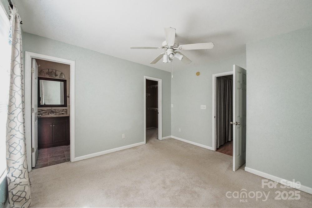 5622 Osprey Cove Drive Raleigh, NC 27604 - Photo 22 of 30 an empty room with closet and a ceiling fan